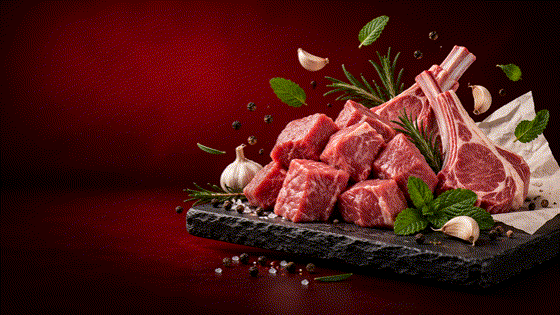 Fresh, clean mutton cuts arranged on a dark serving board with herbs